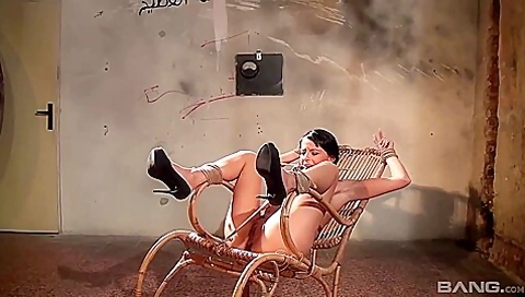 Beautiful Brunette Model Is Bound To A Chair And Wearing A Mouth Bit